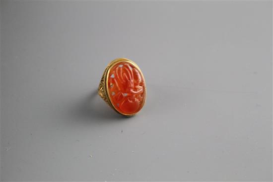 A 14k filigree yellow metal and orange chalcedony set dress ring, carved with fruit, size M, gross weight, 6 grams.